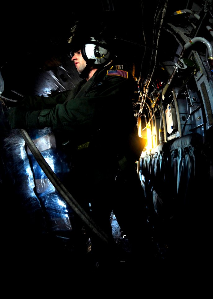 US Navy 100115-N-6006S-064 An aircrew member on board an MH-53E Sea Dragon helicopter straps down fresh drinking water before departing the flight deck of the aircraft carrier USS Carl Vinson (CVN 70)