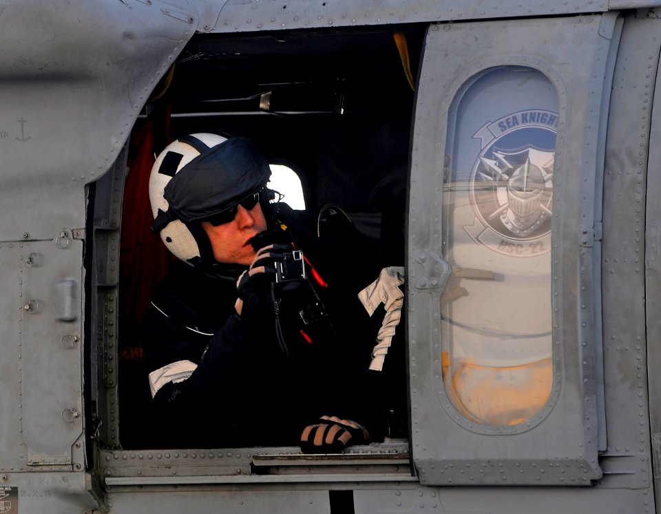 US Navy 100116-N-5345W-072 Naval Air Crewman 2nd Class Christopher Sahagun, assigned to the Sea Knights of Helicopter Sea Combat Squadron (HSC) 22 snaps a picture from aboard an MH-60S Sea Hawk