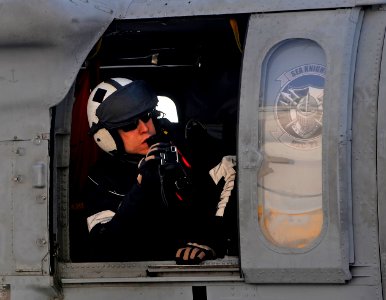 US Navy 100116-N-5345W-072 Naval Air Crewman 2nd Class Christopher Sahagun, assigned to the Sea Knights of Helicopter Sea Combat Squadron (HSC) 22 snaps a picture from aboard an MH-60S Sea Hawk