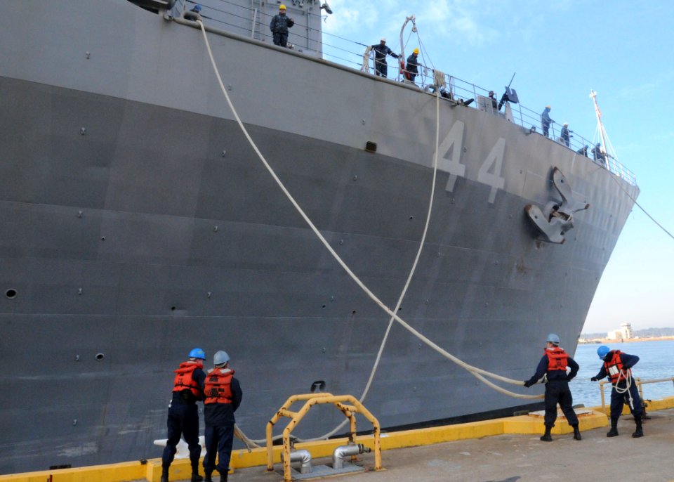 US Navy 100115-N-6764G-093 Line handlers remove mooring lines as the amphibious transport dock ship USS Gunston Hall (LSD 44) departs Joint Expeditionary Base Little Creek-Fort Story