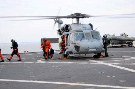 US Navy 100116-N-6410J-123 Medical personnel disembark a MH-60S Knighthawk helicopter assigned to the
