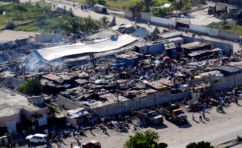 US Navy 100115-N-6247V-495 Haitian citizens gather in a severely damaged compound in Port-Au-Prince, Haiti, three days after the country suffered a 7.0 earthquake disaster on Jan. 12