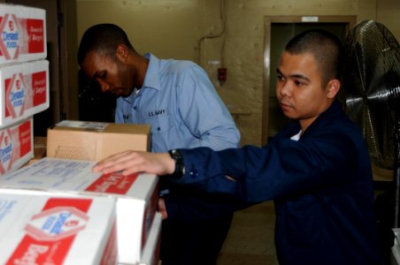 US Navy 100117-N-6410J-020 Sailors transfer food stores to feed the more than 700 civilians and Sailors aboard the Military Sealift Command hospital ship USNS Comfort (T-AH 20) who are participating in Operation Unified Respons