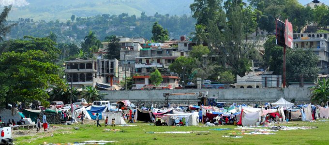 US Navy 100117-N-2953W-167 Haitian earthquake victims in a tent city wait for medical treatment from U.S. Navy and U.S. Coast Guard personnel