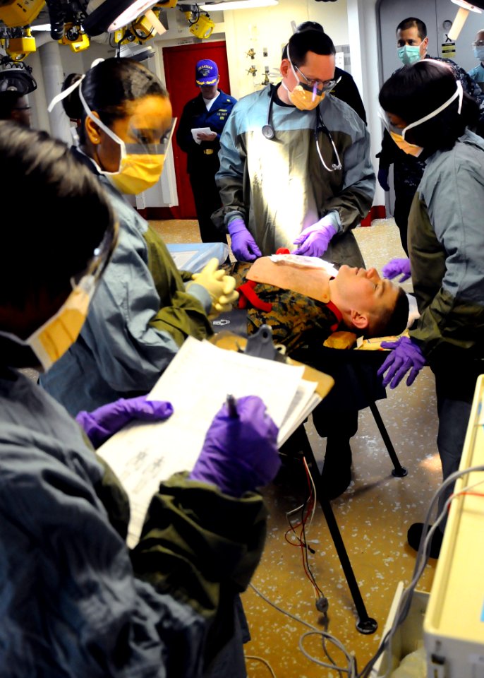 US Navy 100117-N-3165S-077 edical personnel aboard the multi-purpose amphibious assault ship USS Bataan (LHD 5) practice observing patient injuries during photo