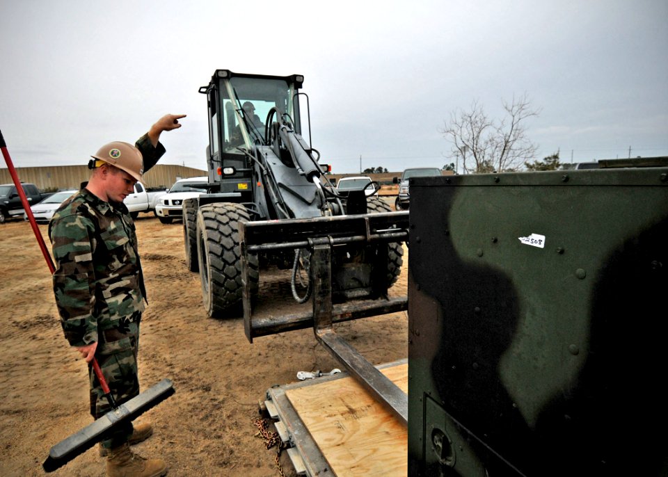 US Navy 100115-N-6889J-021 eabees assigned to Naval Mobile Construction Battalion (NMCB) 7 consolidate pallets at Naval Construction Battalion Center Gulfport