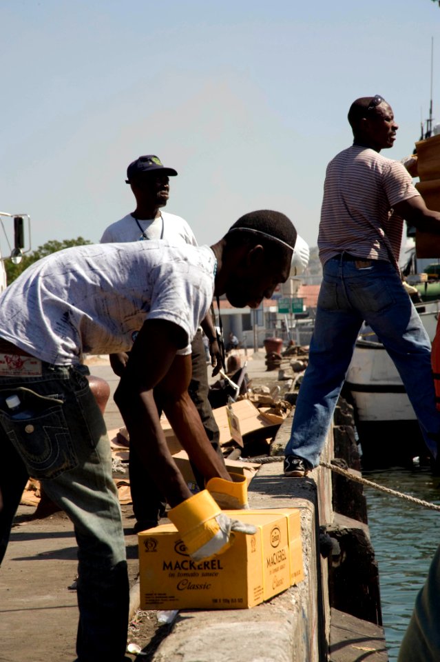US Navy 100118-N-1134L-141 Members of the Jamaican Defense Forces Coast Guard unload supplies in Port-au-Prince