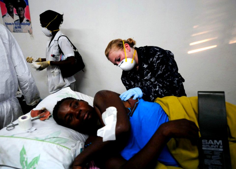 US Navy 100116-N-2953W-266 A U.S. Navy Hospital Corpsman treats an earthquake victim at Killick Haitian Coast Guard Base Clinic