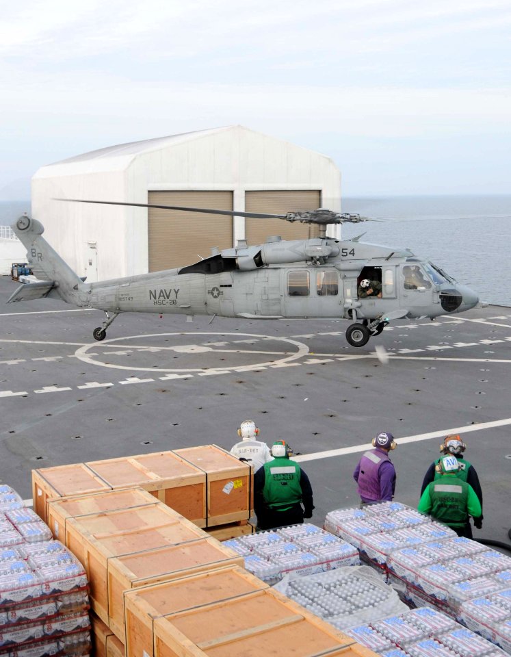 US Navy 100116-N-6410J-146 Sailors aboard USNS Comfort (T-AH 20) prepare to refuel a MH-60S Knighthawk helicopter