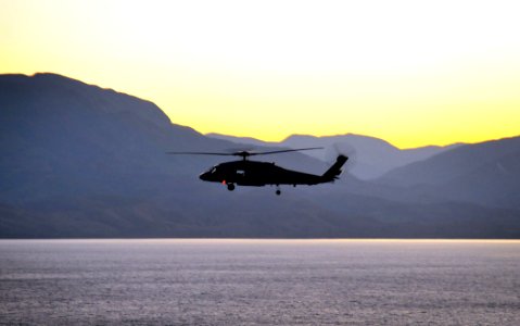 US Navy 100116-N-4774B-024 An SH-60F Seahawk helicopter flies to Haiti to deliver water and supplies as part of relief efforts for those affected by the recent earthquake photo