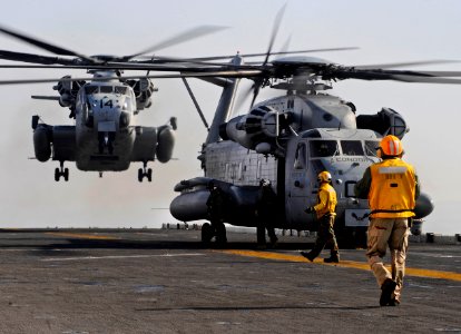 US Navy 100116-N-5345W-039 A pair of CH-53E Super Stallions from the Ironhorse of Marine Heavy Helicopter Squadron (HMH) 461 prepares to touch down on the multi-purpose amphibious assault ship USS Bataan (LHD 5) photo