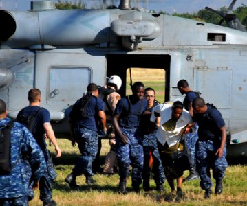US Navy 100118-N-4774B-064 U.S. Navy Sailors assist a woman from an SH-60S Sea Hawk helicopter assigned to the aircraft carrier USS Carl Vinson (CVN 70) to awaiting medical personnel