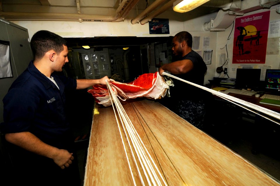 US Navy 100119-N-3038W-116 ailors perform maintenance on a parachute aboard the aircraft carrier USS Nimitz (CVN 68)