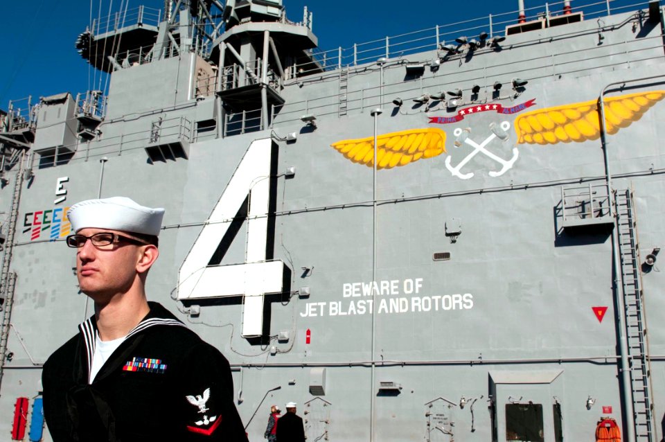 US Navy 100118-N-5712P-066 viation Ordnanceman 3rd Class Daniel Kegel mans the rails of the amphibious assault ship USS Nassau (LHA 4)