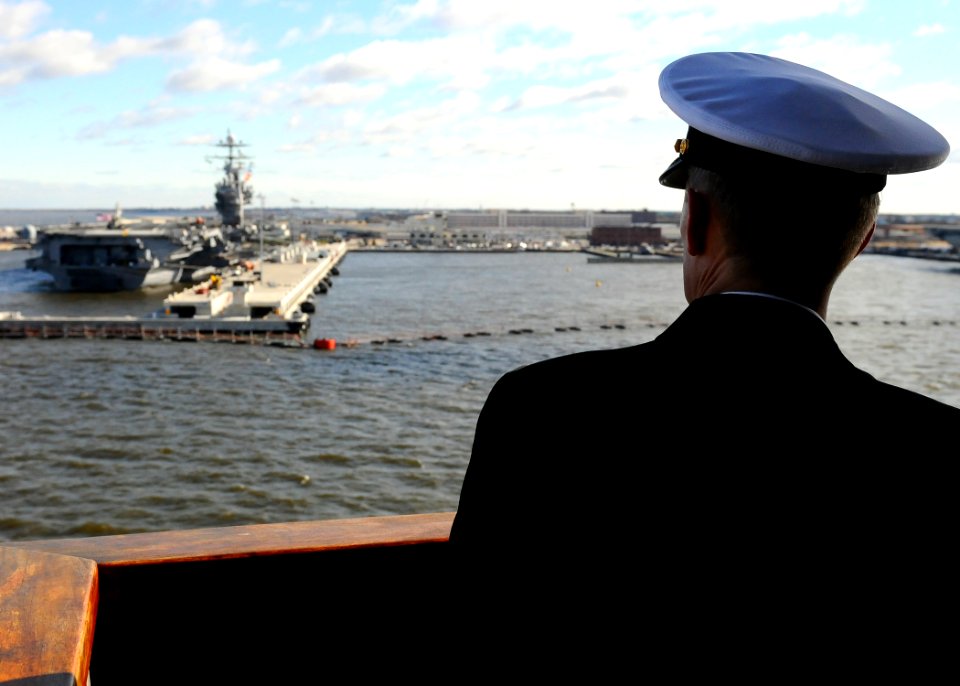 US Navy 100118-N-2735T-243 Capt. John G. Bruening, commodore of Amphibious Squadron (AS) 8, looks out as the amphibious assault ship USS Nassau (LHA 4) departs Naval Station Norfolk