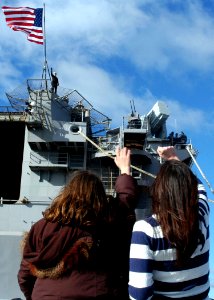 US Navy 100118-N-6764G-076 Family members of Lt. Scott Moak, the hangar bay officer aboard the amphibious assault ship USS Nassau (LHA 4), wave goodbye as Nassau pulls away from the pier