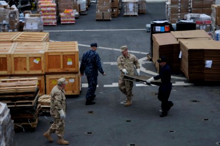 US Navy 100116-N-6410J-057 Sailors aboard USNS Comfort (T-AH 20) organize supplies for their deployment to support humanitarian relief efforts in Haiti