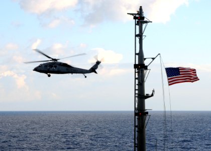 US Navy 100119-N-4236E-017 An MH-60S Sea Hawk helicopter assigned to the Chargers of Helicopter Sea Combat Squadron (HSC) 26 flies by the Military Sealift Command fast combat support ship USNS Supply (T-AOE 6)