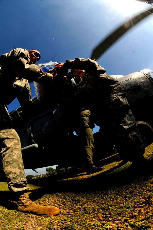 US Navy 100118-N-6006S-056 Soldiers from the 82nd Airborne Division from Ft. Bragg, N.C., unload fresh drinking water in Port-au-Prince, Haiti
