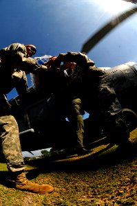 US Navy 100118-N-6006S-056 Soldiers from the 82nd Airborne Division from Ft. Bragg, N.C., unload fresh drinking water in Port-au-Prince, Haiti