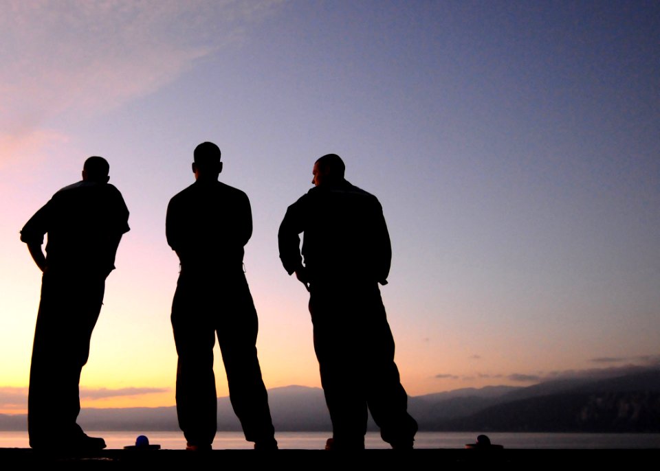 US Navy 100119-N-1092P-092 Sailors watch the sunrise over Haiti from the flight deck of the amphibious assault ship USS Bataan (LHD 5)