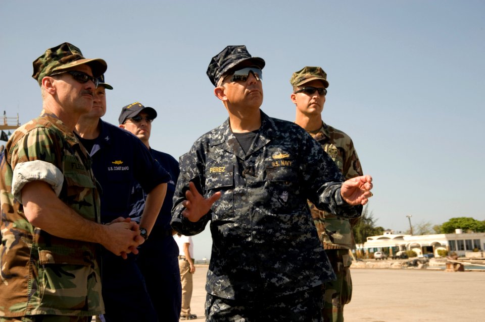 US Navy 100118-N-1134L-175 Capt. Dale Fleck, commodore of Explosive Ordnance Disposal (EOD) Group 2, left, discusses his assessment of the damage to port facilities