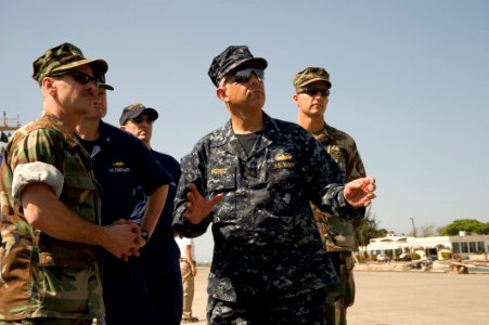 US Navy 100118-N-1134L-175 Capt. Dale Fleck, commodore of Explosive Ordnance Disposal (EOD) Group 2, left, discusses his assessment of the damage to port facilities