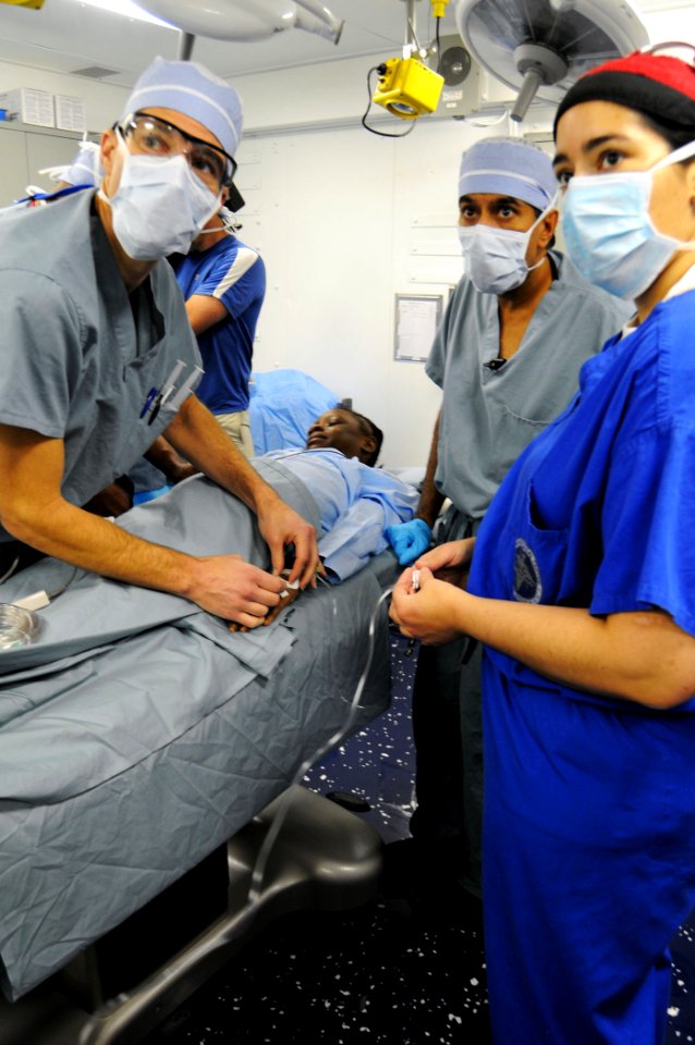 US Navy 100118-N-8878B-100 Surgeons perform surgery on a 12-year-old Haitian girl with a severe head injury aboard the Nimitz-class aircraft carrier USS Carl Vinson (CVN 70)