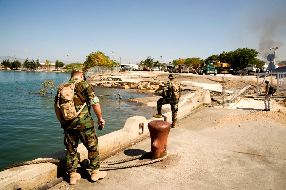 US Navy 100118-N-1134L-209 Chief Warrant Officer 3 Lowell Schrader assesses port facilities during an inspection of the port in Port-au-Prince, Haiti