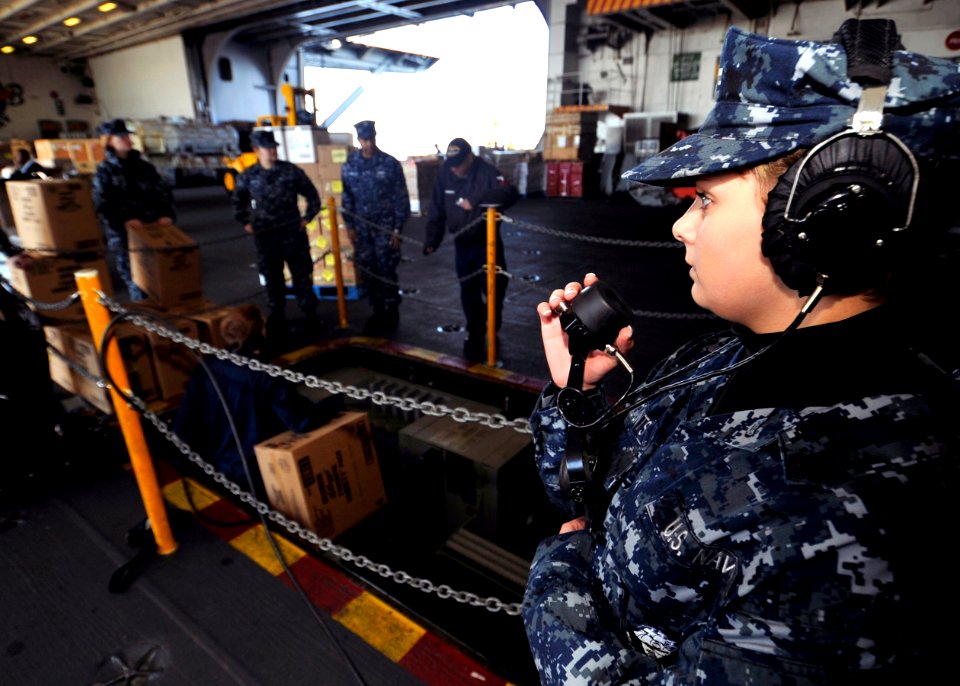 US Navy 100119-N-6003P-003 Aviation Boatswain's Mate (Fuel) Airman Ashley Counts, from Godfrey, Ill., uses a sound-powered telephone during a supply onload aboard the Nimitz-class aircraft carrier USS Harry S. Truman (CVN 75)