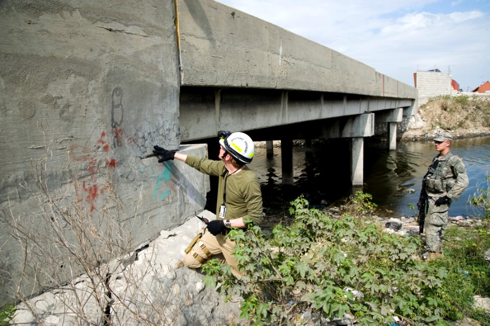 US Navy 100119-N-1134L-160 Brian Crowder, a civilian structural engineer employed by Naval Facilities Atlantic, assess the structural integrity of a bridge after a 7.0 magnitude earthquake