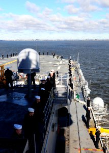 US Navy 100118-N-2735T-226 Sailors aboard the amphibious assault ship USS Nassau (LHA 4) man the rails as the ship departs Naval Station Norfolk on a regularly scheduled deployment