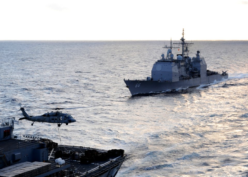 US Navy 100119-N-4236E-161 he guided-missile cruiser USS Hue City (CG 66) prepares for a replenishment at sea while an MH-60S Sea Hawk helicopter