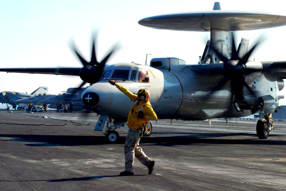 US Navy 100118-N-3589B-096 Lt. j.g. Christopher Miller directs an E2-C Hawkeye assigned to the Wallbangers of Carrier Airborne Early Warning Squadron