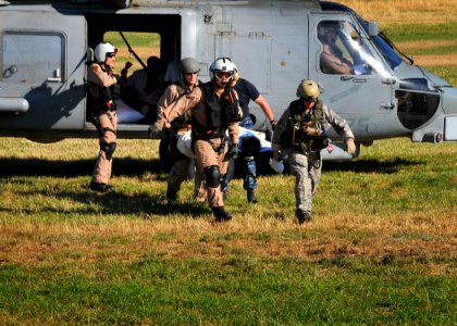 US Navy 100118-N-4774B-049 U.S. military servicemen transport a patient from an SH-60F Sea Hawk helicopter assigned to the aircraft carrier USS Carl Vinson (CVN 70) to medical personnel during humanitarian relief efforts in Por
