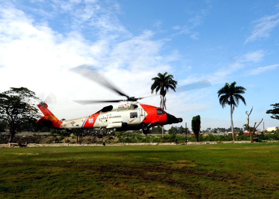 US Navy 100119-N-6676S-006 A U.S. Coast Guard HH-60J Jayhawk helicopter leaves the soccer field at the Killick Haitian Coast Guard Base to transport earthquake victims