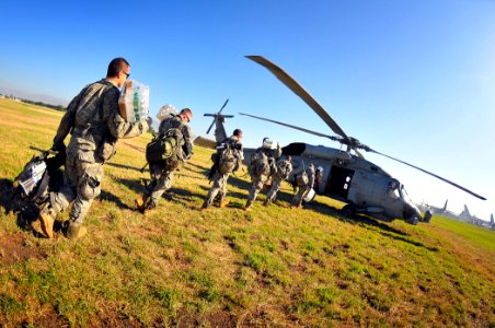 US Navy 100118-N-4774B-386 U.S. Army Soldiers load water and supplies into an SH-60S Sea Hawk helicopter from the Nimitz-class aircraft carrier USS Carl Vinson (CVN 70)