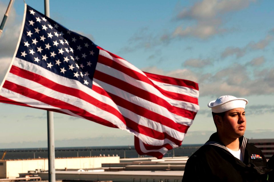 US Navy 100118-N-5712P-061 Aviation Ordnanceman Airman Lawrence Taylor mans the rails of the amphibious assault ship USS Nassau (LHA 4)