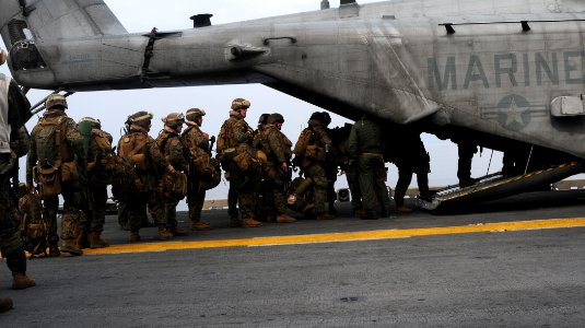 US Navy 100119-N-7508R-037 Marines board a CH-53E Super Stallion helicopter aboard USS Bataan (LHD 5) photo