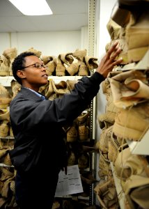 US Navy 100119-N-6326B-066 nformation Systems Technician 3rd Class Tiffaney L. Pitterman looks for desert combat boots at the Naval Mobilization Processing Site San Diego