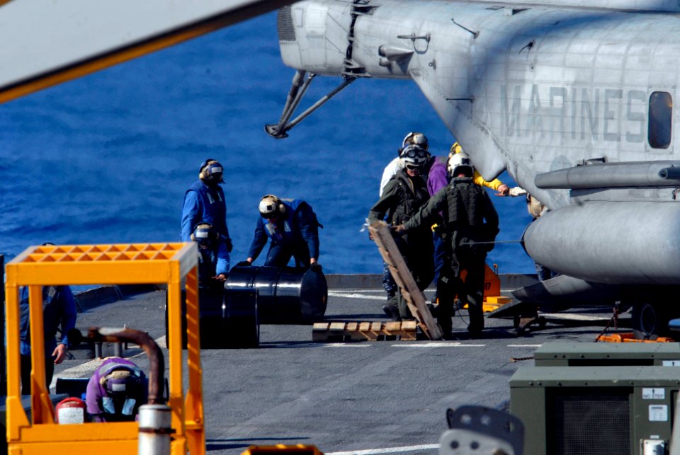 US Navy 100118-N-7653W-036 ailors aboard the amphibious dock landing ship USS Fort McHenry (LSD 43) conduct a replenishment at sea as they prepare to support Operation Unified Response
