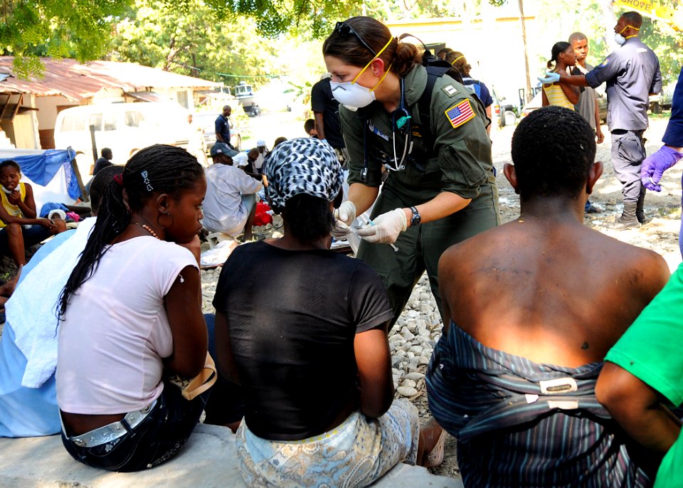 US Navy 100119-N-6247V-153 Lt. Kristina Rogish, a surgeon assigned to the aircraft carrier USS Carl Vinson (CVN 70), treats several injured Haitians at the Killick Haitian Coast Guard Clinic in Carrefour, Haiti
