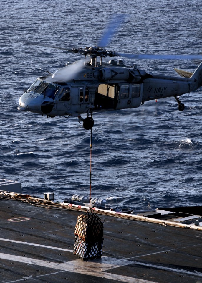 US Navy 100119-N-4236E-066 An MH-60S Sea Hawk helicopter assigned to the Chargers of Helicopter Sea Combat Squadron (HSC) 26 performs a vertical replenishment between the Military Sealift Command