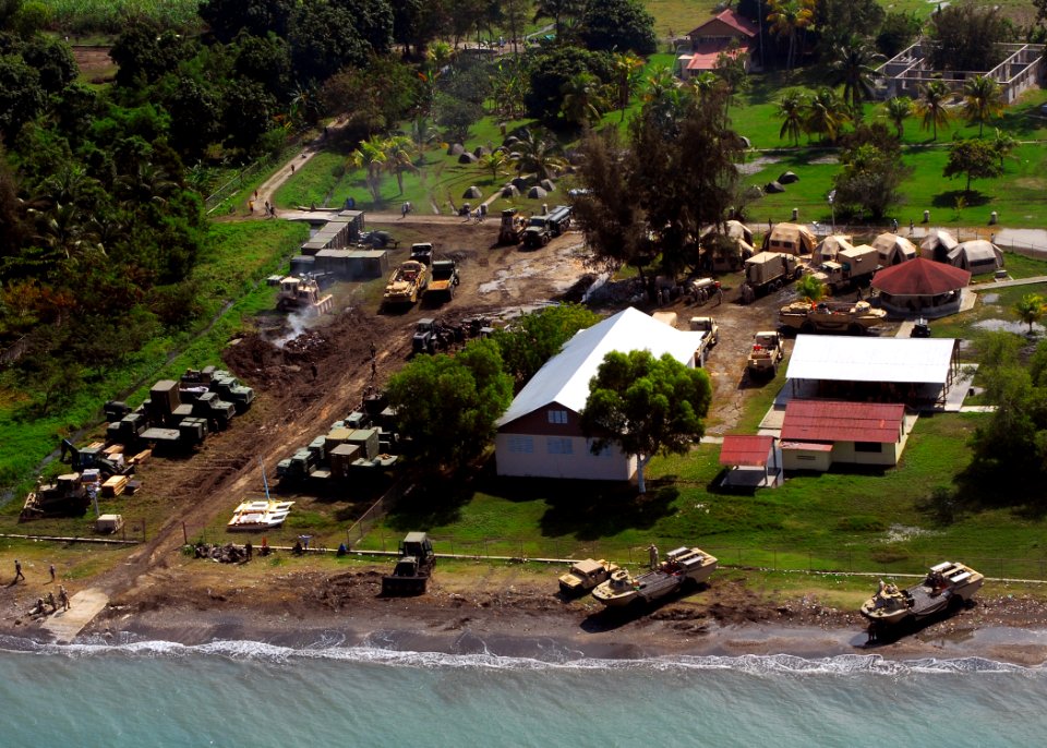 US Navy 100120-N-3165S-218 Military personnel and vehicles sit at the New Hope Mission preparing the landing zone to operations to assist in the flow of relief supplies ashore