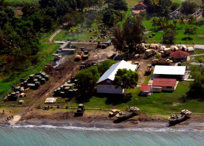 US Navy 100120-N-3165S-218 Military personnel and vehicles sit at the New Hope Mission preparing the landing zone to operations to assist in the flow of relief supplies ashore photo