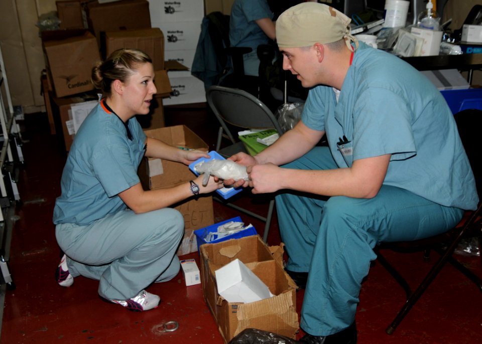 US Navy 100118-N-6410J-023 Hospital Corpsman 3rd Class Bridgette Short, left, and Hospital Corpsman 3rd Class Mathew Vinyard inventory medical supplies aboard the Military Sealift Command hospital ship USNS Comfort (T-AH 20)