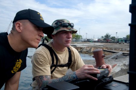 US Navy 100119-N-1134L-035 Capt. Scott Sann, commander of the 544th Engineer Dive Team, left, and Army diver Staff Sgt. William D'Angelo operate a remotely operated vehicle