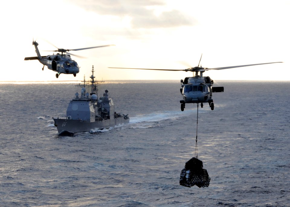 US Navy 100119-N-4236E-140 The guided-missile cruiser USS Hue City (CG 66) prepares for a replenishment at sea while MH-60S Sea Hawk helicopters