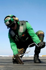 US Navy 100120-N-3038W-243 A Sailor prepares a catapult track for flight operations aboard the aircraft carrier USS Nimitz (CVN 68) photo