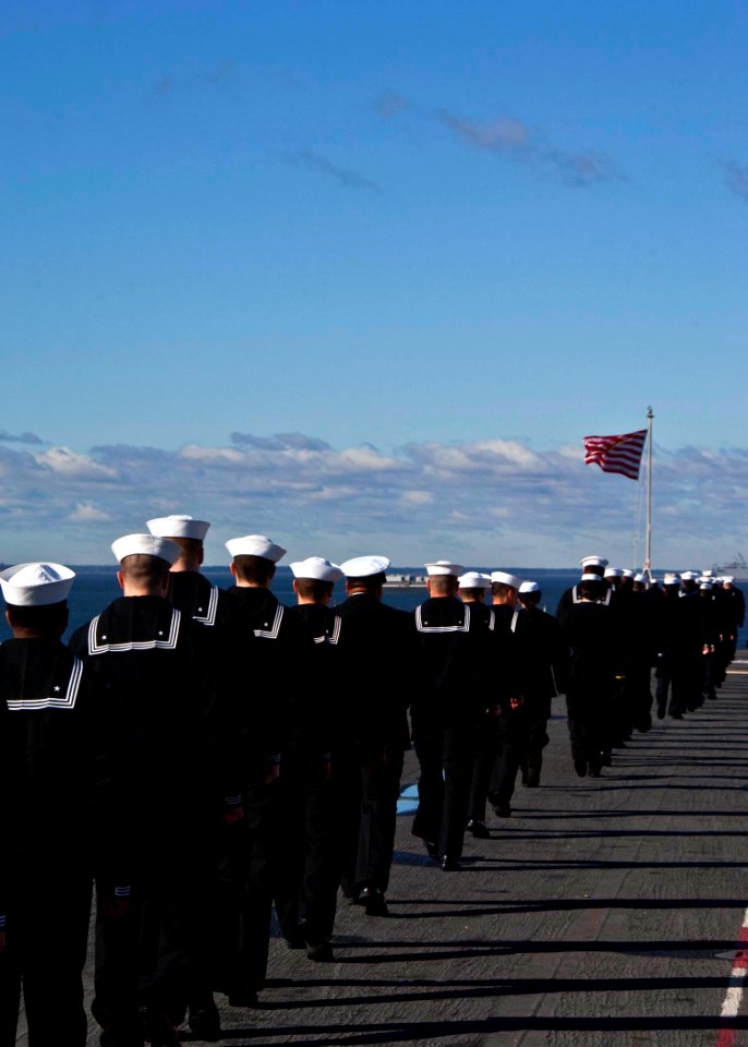 US Navy 100118-N-9327W-016 Sailors aboard the amphibious assault ship USS Nassau (LHA 4) prepare to man the rails before the ship departs Naval Station Norfolk